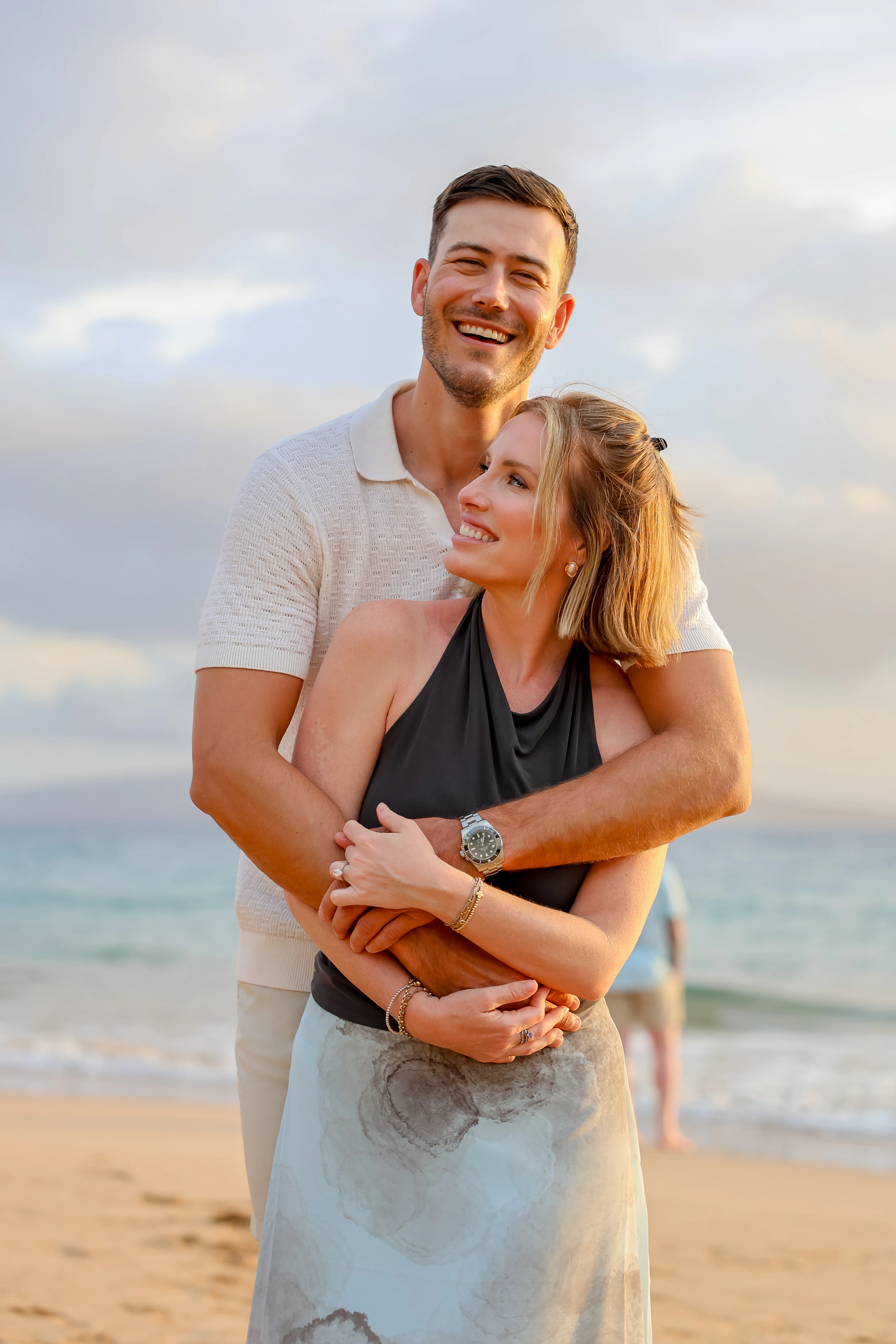Couple laughing in an embrace on a Maui beach