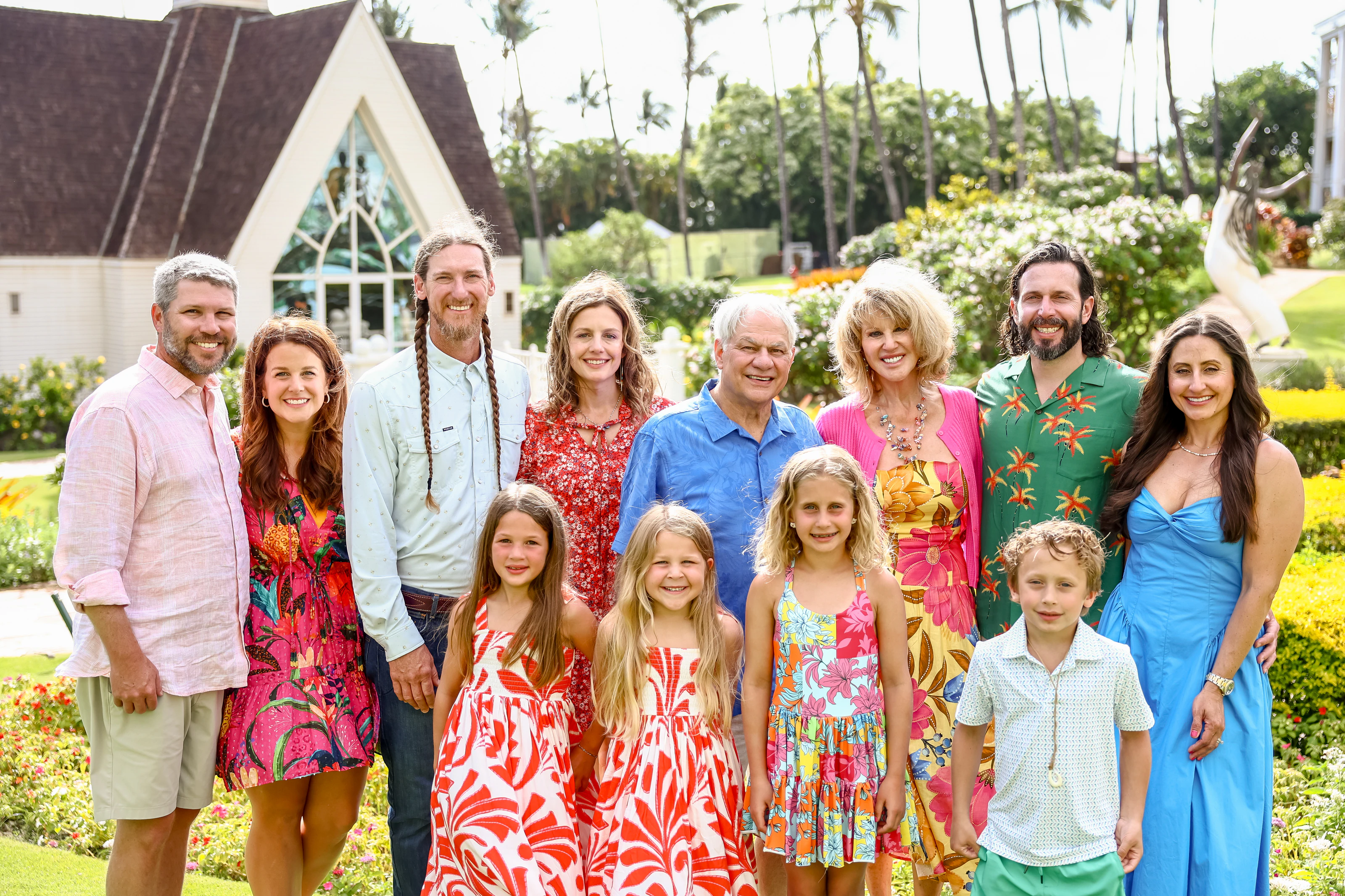 Multigenerational family smiling together in a Maui garden