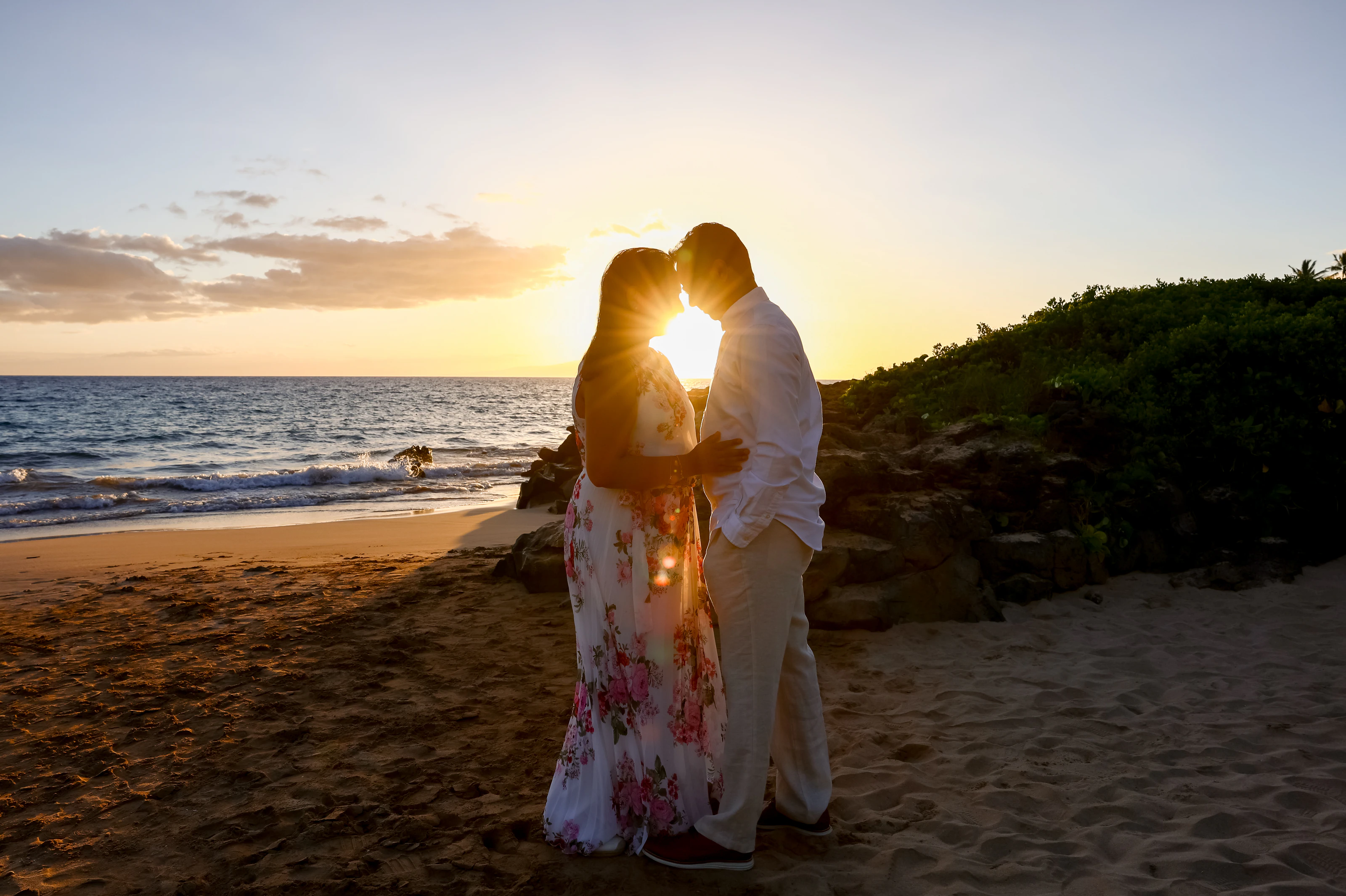 Couple touching foreheads on a Maui beach at sunset